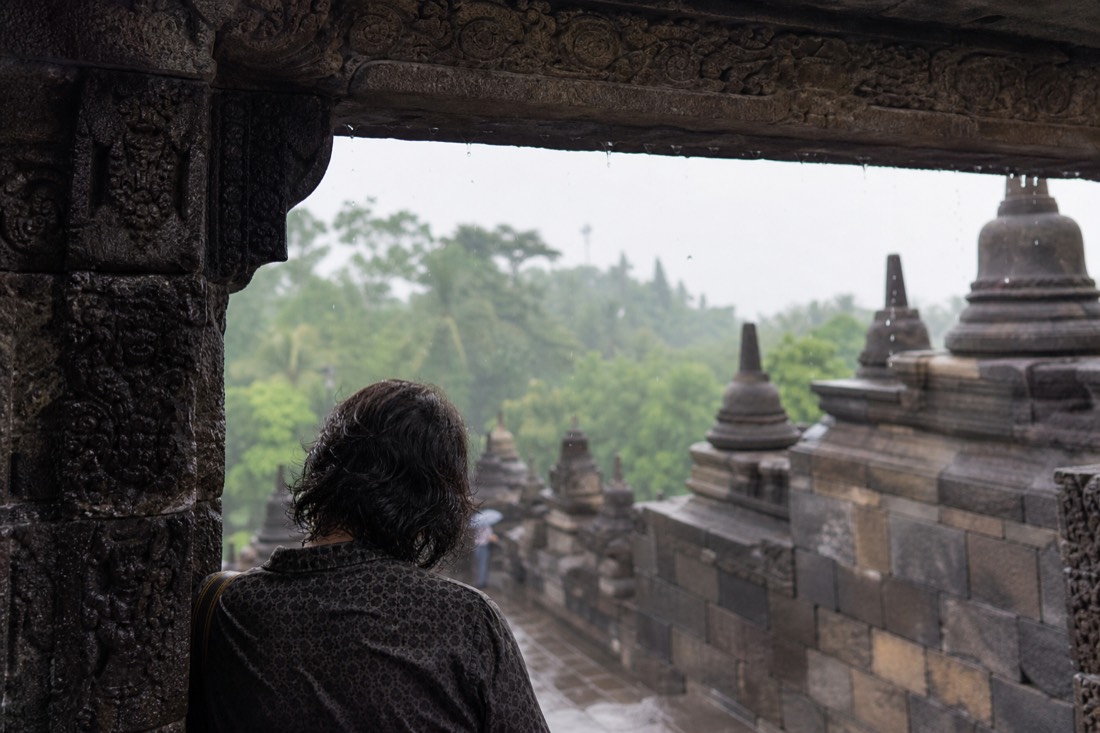Sheltering from a downpour under a gateway of Borobudur