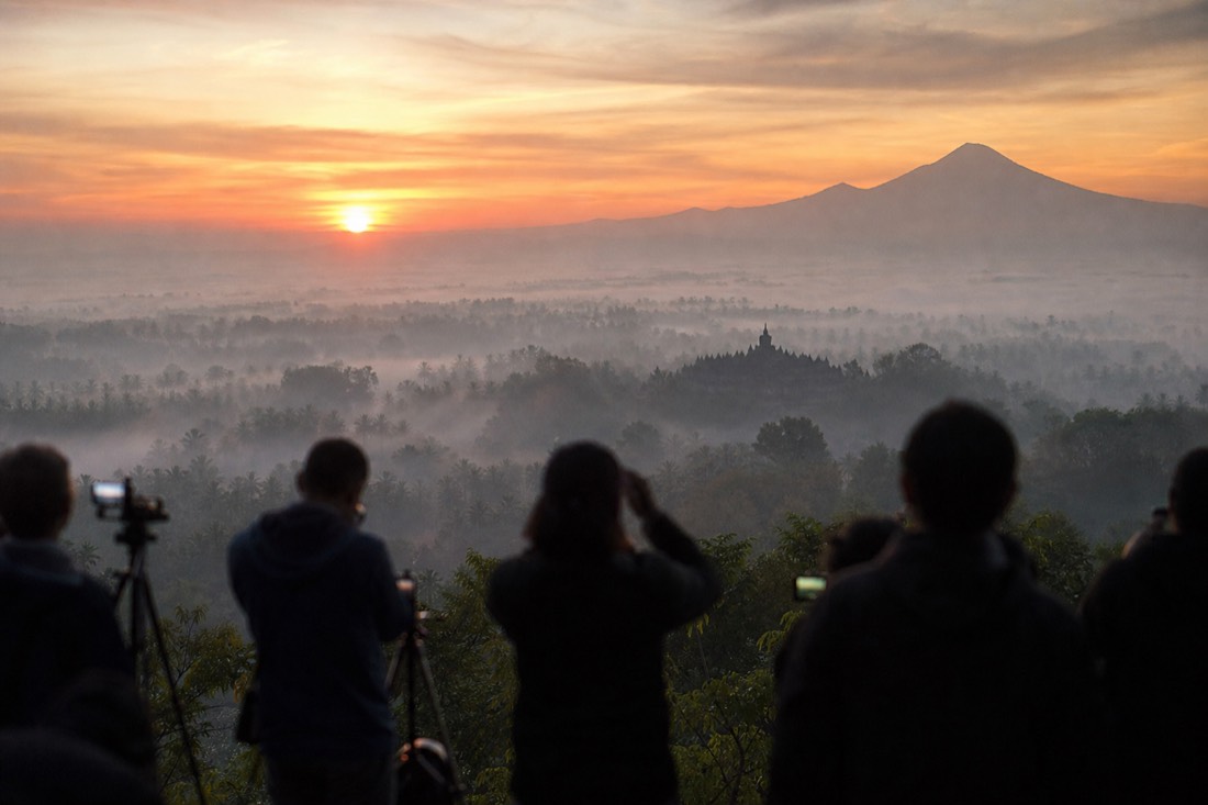 Dawn from Punthuk Setumbu hill: Borobudur temple silhouetted above the mist across the Kedu Plain